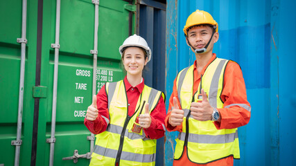 Woman foreman with Operator smile thumb up at side of Cargo forklift in warehouse , Manager use tablet in white helmet Safety Supervisor in Container Custom Terminal port concept import export
