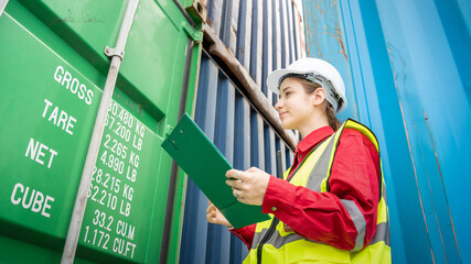 Woman inspector foreman Checking Cargo in Container cargo CustomTerminal port, Foerman use Clipboard paper for checking cargo concept  import export transportation and logistic insurance service