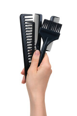 Fototapeta na wymiar A female hand holds professional hairdressing tools, a brush for hair coloring, different combs in black. Isolated on white background. Providing all hairdressing services