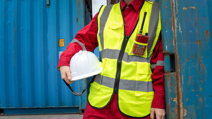 Lady foreman holding helmet after finnish work in front of cargo container. Foreman relaxing front fo Cargo at warehouse logistics transportation