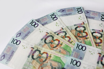 Banknotes of 100 belarusian rubles laid out on an isolated background