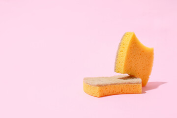 Household sponges on color background