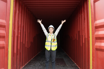 Success Lady manager cargo container show hand up indise large cargo success concept. success logistic transportation business