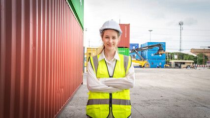 Woman foreman smile at side of Cargo container in warehouse , Manager in white helmet Safety Supervisor in Container Custom Terminal port concept import export