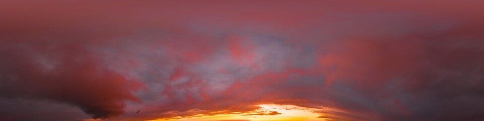 Burning red dramatic overcast dark sunset sky panorama. Hdr seamless spherical equirectangular 360 panorama. Sky dome or zenith for 3D visualization and sky replacement for aerial drone 360 panoramas.