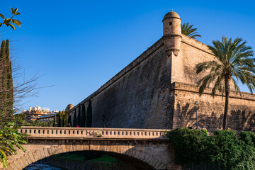 The bastion of Sant Pere from the bridge where a river flows. Photography made in Mallorca, Balearic Islands, Spain.