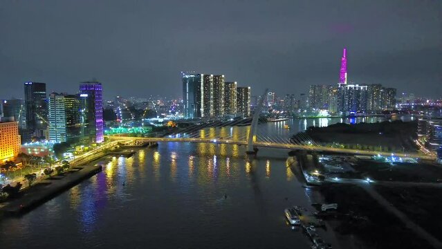 Aerial view of Bitexco Tower, buildings, roads, Thu Thiem 2 bridge and Saigon river in Ho Chi Minh city - Far away is Landmark 81 skyscraper. Travel concept.