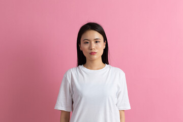 Fototapeta premium Portrait of asian woman on pink background.