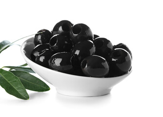 Bowl of tasty black olives on white background