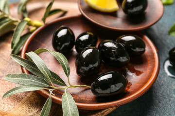 Plate of tasty black olives, closeup