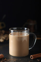 A cup with masala chai in low key