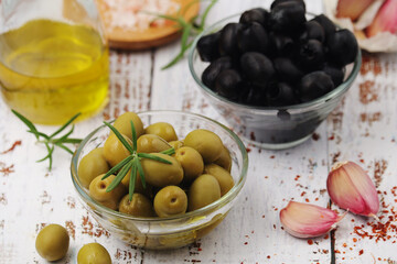 Black and green olives in glass bowls