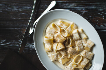 Restaurant serving pasta with parmesan and pepper. Food photography. Table setting.