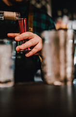 man bartender hand making negroni cocktail. Negroni classic cocktail and gin short drink with sweet vermouth, red bitter liqueur