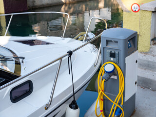 yachts and motor boat in marina port, front view