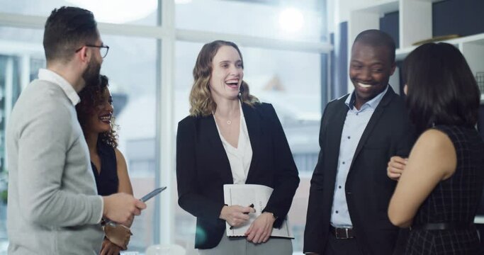 Cheerful, business people, networking and laughing in friendly conversation at modern corporate office. Team of executive, professional work colleagues talking together at formal company