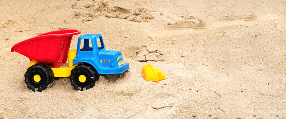Fototapeta na wymiar Toy truck in a sandbox
