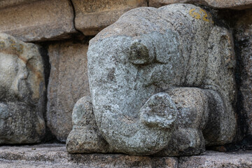 Carved  stone elephant on building structure.