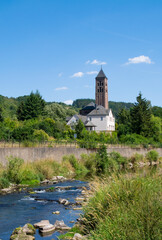 view of the evangelical church along the river Kyll in the city center of the touristic village of Gerolstein in the German Eifel - obrazy, fototapety, plakaty