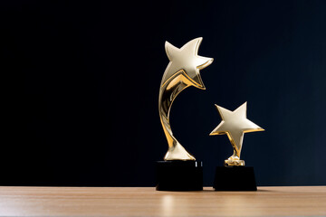 Golden star trophies on wooden table