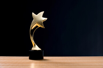 Golden star trophy on wooden table