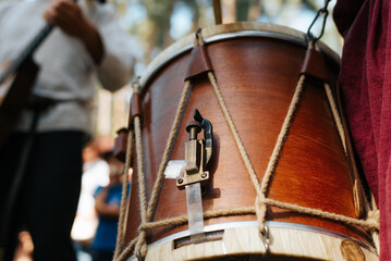 Musician playing ethnic drum folk music at outdoor entertainment. Close-up, selective focus