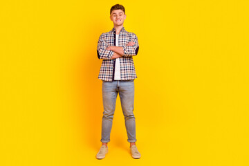 Fototapeta premium Full size photo of young cheerful man confident crossed hands wear casual clothes isolated over yellow color background