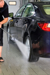 Fototapeta na wymiar self-washing the car with a strong water jet