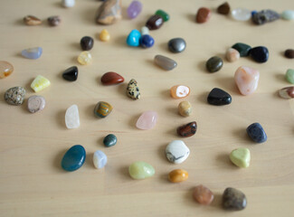 colored stones and minerals lie on the table in daylight. Exhibition of stones, sale, trade, selection. Fair, Good Buy