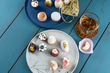 Wedding sweet treat next to chocolate cups with whipped cream, truffles, walnut cameo and whiskey...