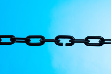 Black plastic chain on blue background