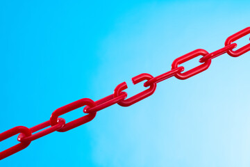 Fototapeta premium Red plastic chain on blue background