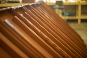 Wooden products in carpentry workshop. Blanks made of wood. Furniture board.