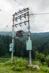 June 16th 2021 Uttarakhand India. Electricity poles with overhead transformers in remote areas with mountains and forest in the background.