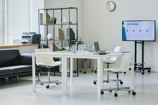 Horizontal image of modern office with table in the middle for business meeting