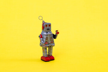 Retro robot toy on yellow background