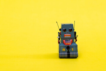 Retro robot toy on yellow background