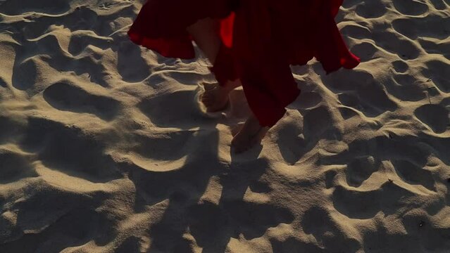 Close up high angle shot of bare feet doing flamenco tap dancing on beach sand