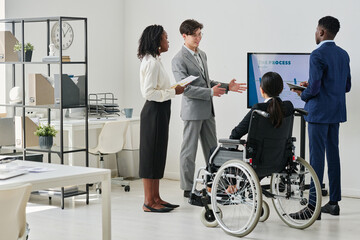 Group of business people working in team discussing new business plan during presentation at office