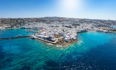 Beautiful, panoramic aerial view of Mykonos town with white buildings and turquoise sea during summer time, Cyclades, Greece - obrazy, fototapety, plakaty