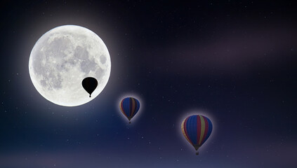 Balloons flying on a moonlit night