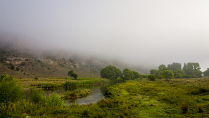 Camping in the nature waking up into a misty sunrise