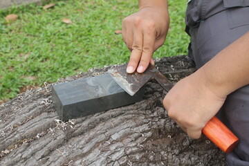 the activity of sharpening an axe on a whetstone