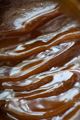Golden honey - liquid and shiny background. Selective focus.