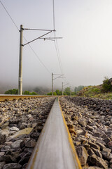 Fototapeta na wymiar Railroad in the nature on a foggy morning
