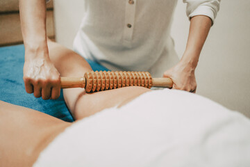 masseur doing a massage with a tool in her beauty center