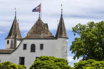 turret of castle of Nyon and flag of canton of Vaud in Switzerland © hectorchristiaen