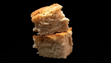 Squares of Italian Focaccia bread on a black background