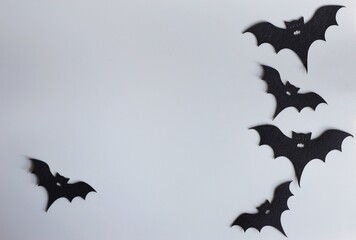 Five silhouettes of bats on a gray background. Creative halloween concept backdrop. halloween bats craft.