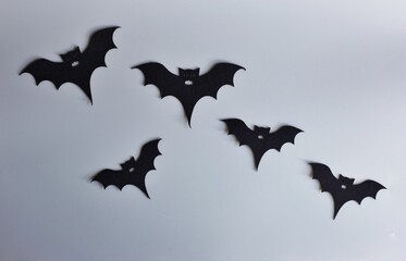 Five silhouettes of bats on a gray background. Creative halloween concept backdrop. halloween bats craft.